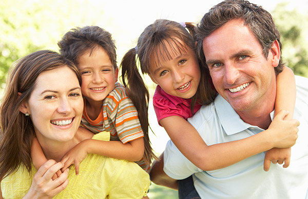 A happy family of 4 smiling