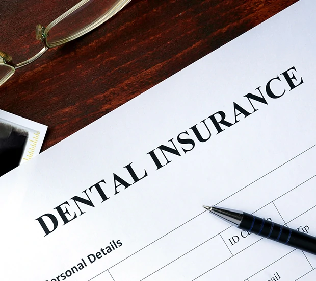Dental insurance form on a polished desk, ready for completion.